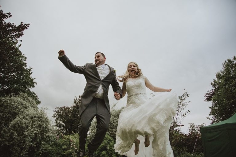 bride and groom jumping in the air
