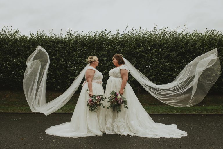 Two brides at Skitby House, their veil blowing in the wind.