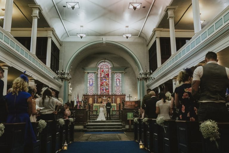A bride and groom having a traditional wedding in a church.