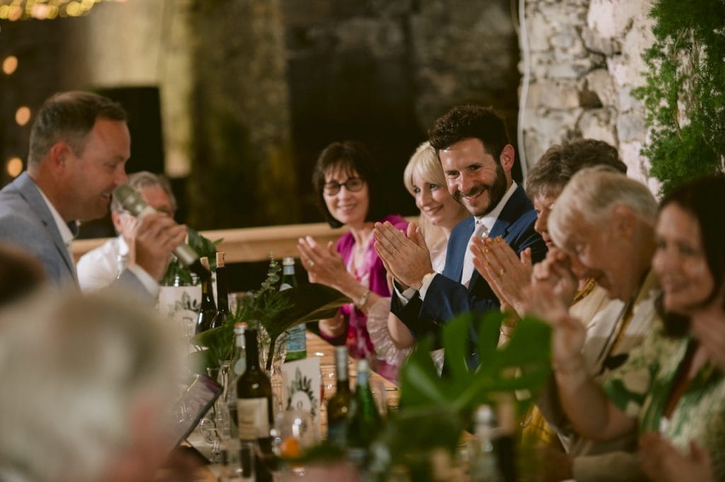 Bride and Groom and Guests Clapping and Laughing Together Portrait Session
