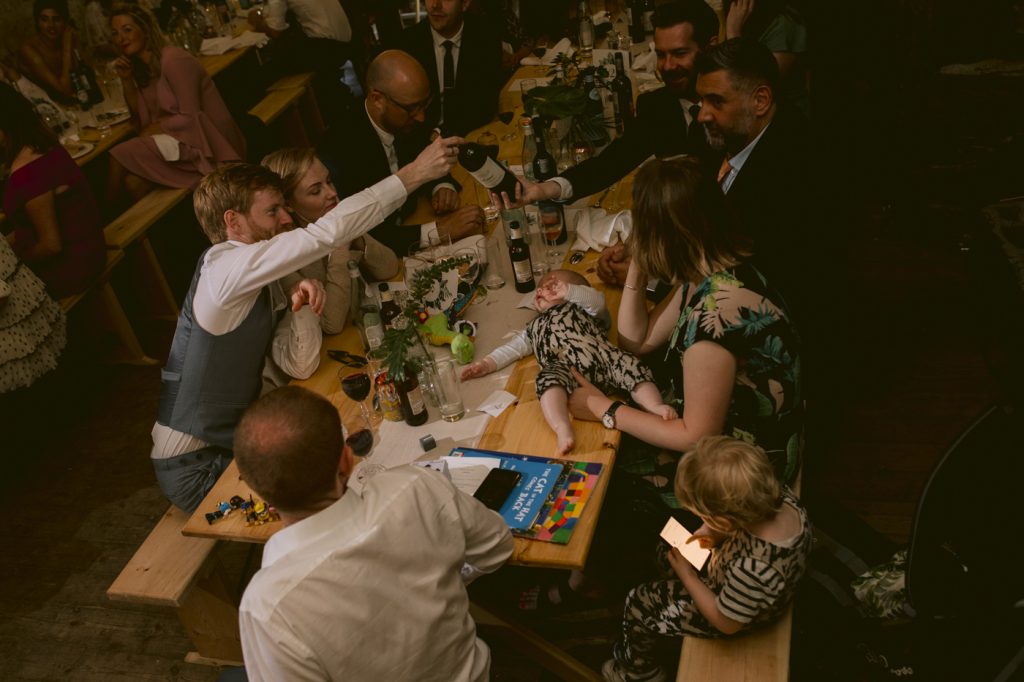 Guests Passing The Wine Overhead Shot Portrait Session