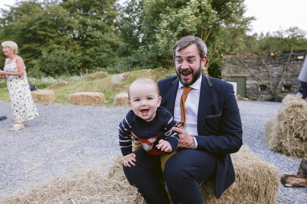 Guest with Baby on Lap Laughing and Smiling Portrait Shot