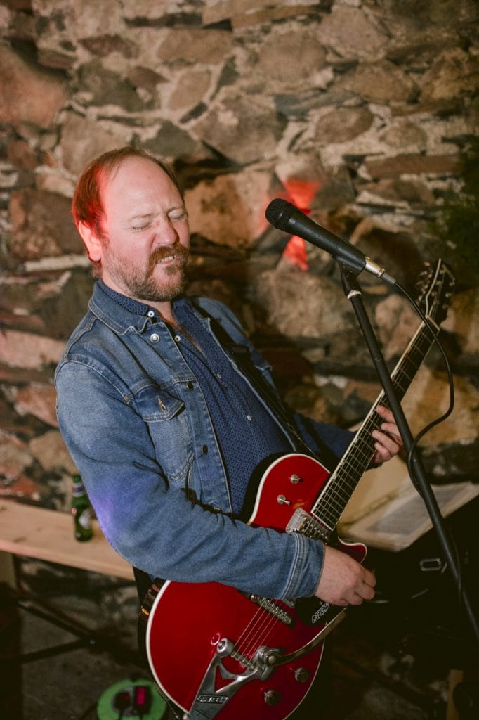 Portrait Session in Main Hall of Guitarist Playing on Electric Guitar