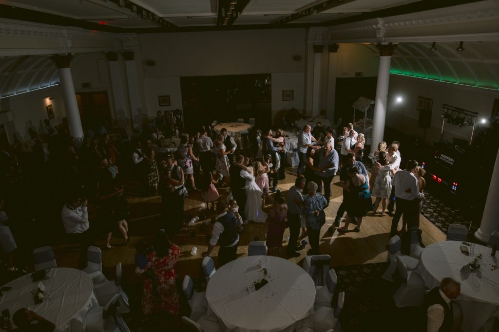 A group of people dancing at a Crown and Mitre Hotel wedding reception.