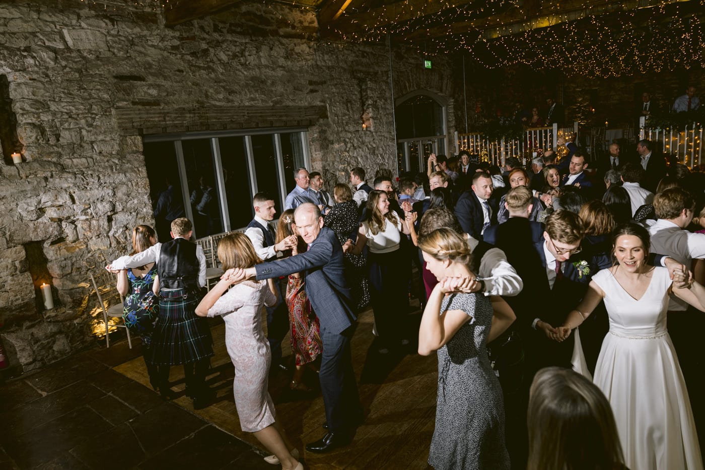 A group of people dancing at the Askham Hall wedding reception.