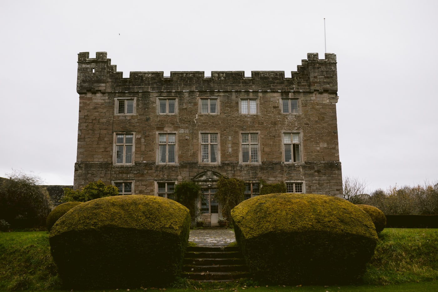 Askham Hall, an old castle with bushes in front of it.