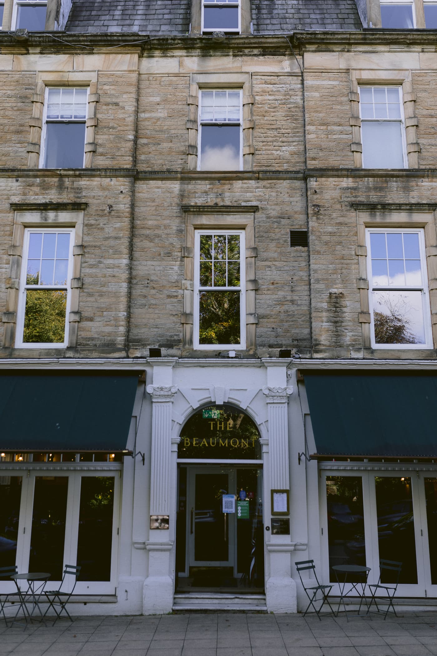 Hexham House, a brick building with a green awning, is the perfect venue for a memorable wedding celebration.