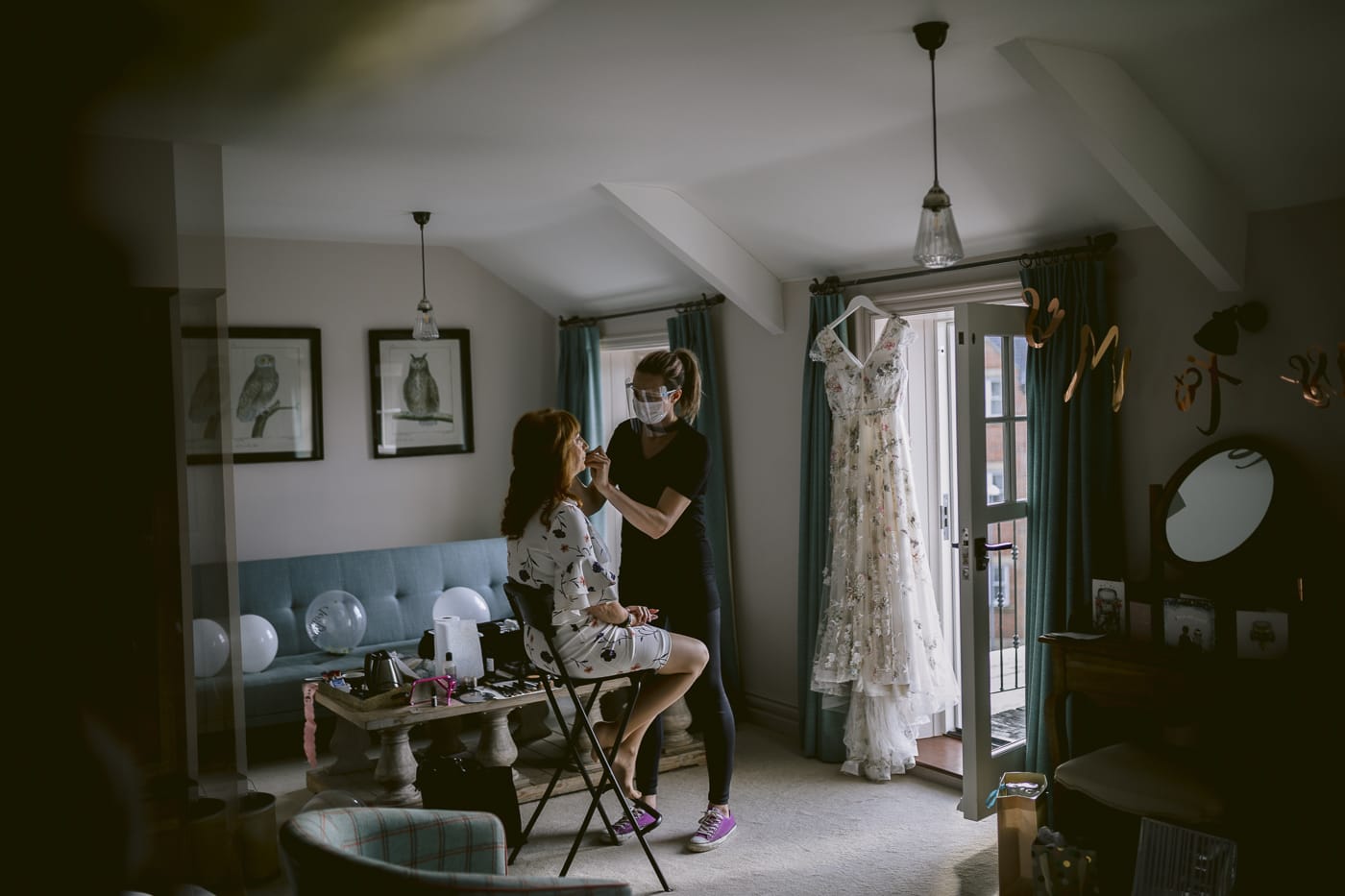 A breathtaking Hexham House bride getting ready in a room with a mirror.
