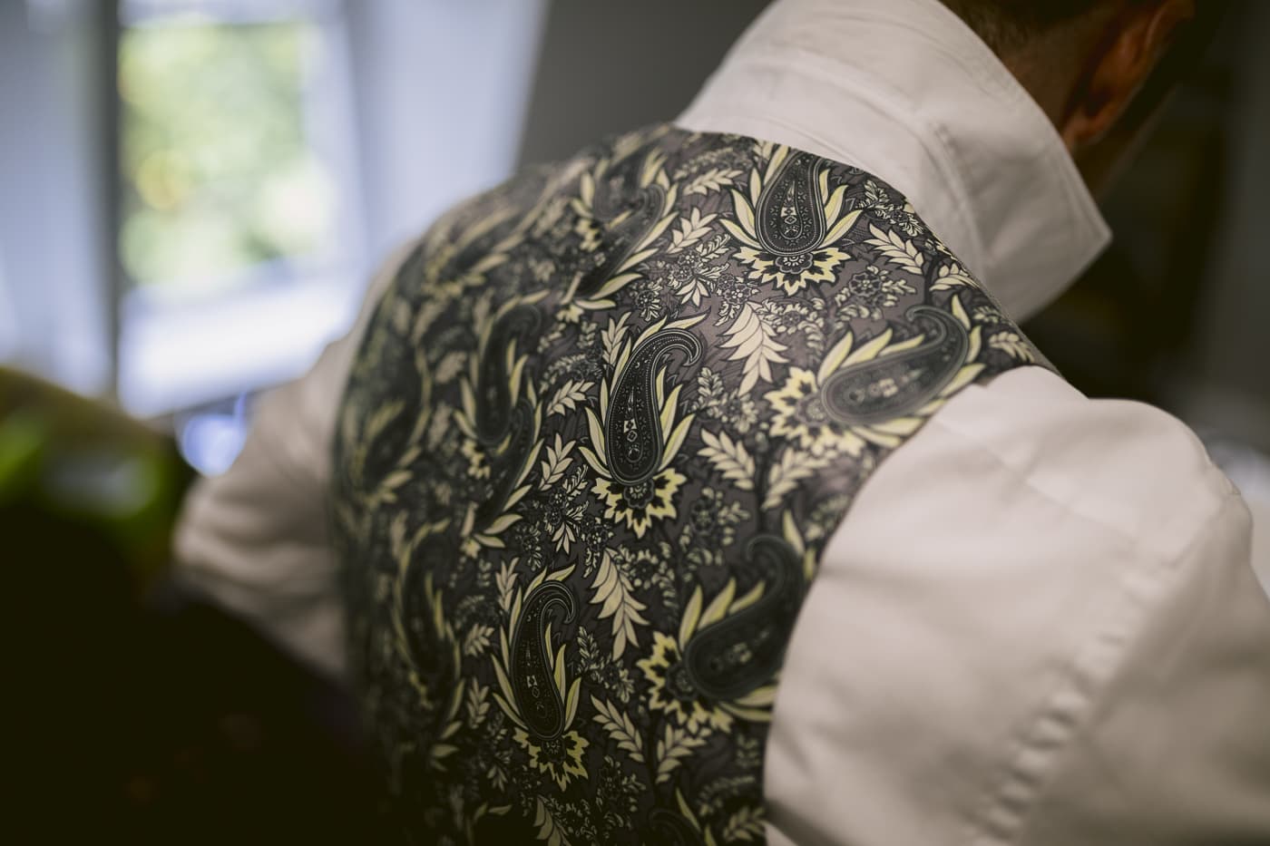 The back of a man's vest with a floral pattern, perfect for a Hexham House Wedding.