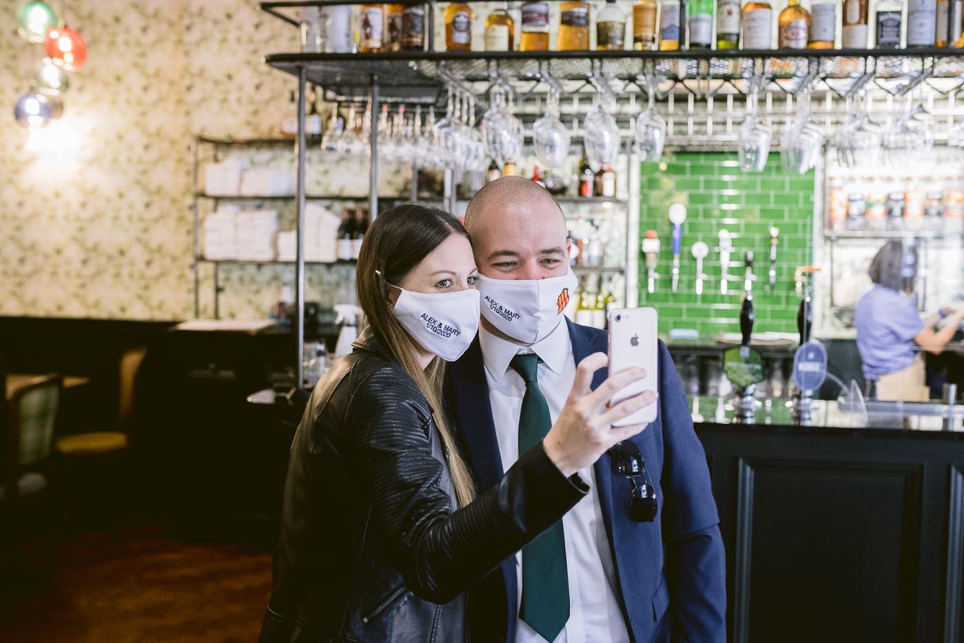 A man and woman wearing face masks taking a selfie at Hexham House Wedding.