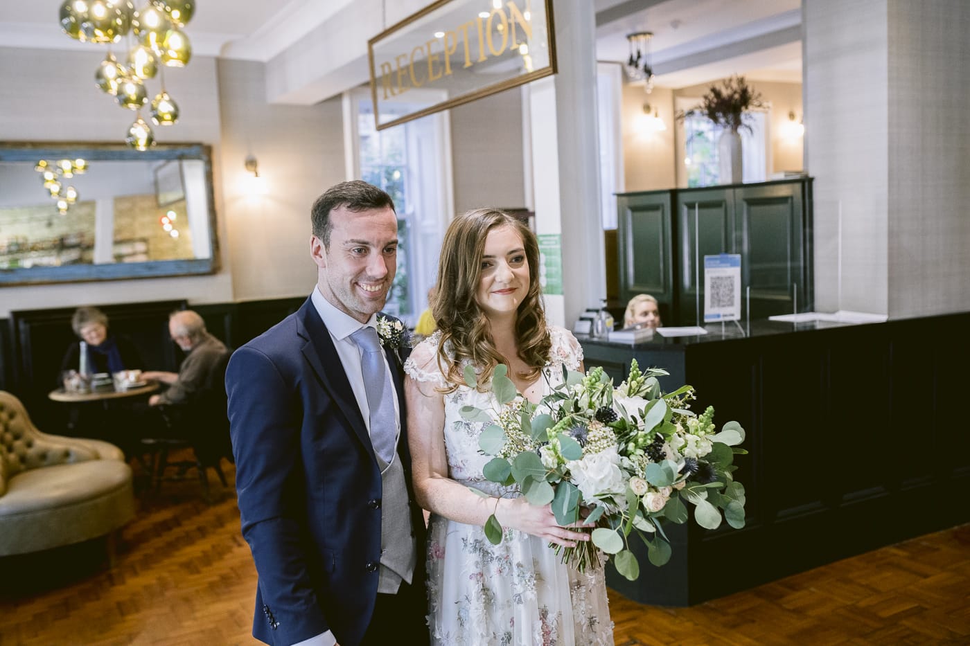 A Hexham House wedding couple standing in the lobby of a hotel.