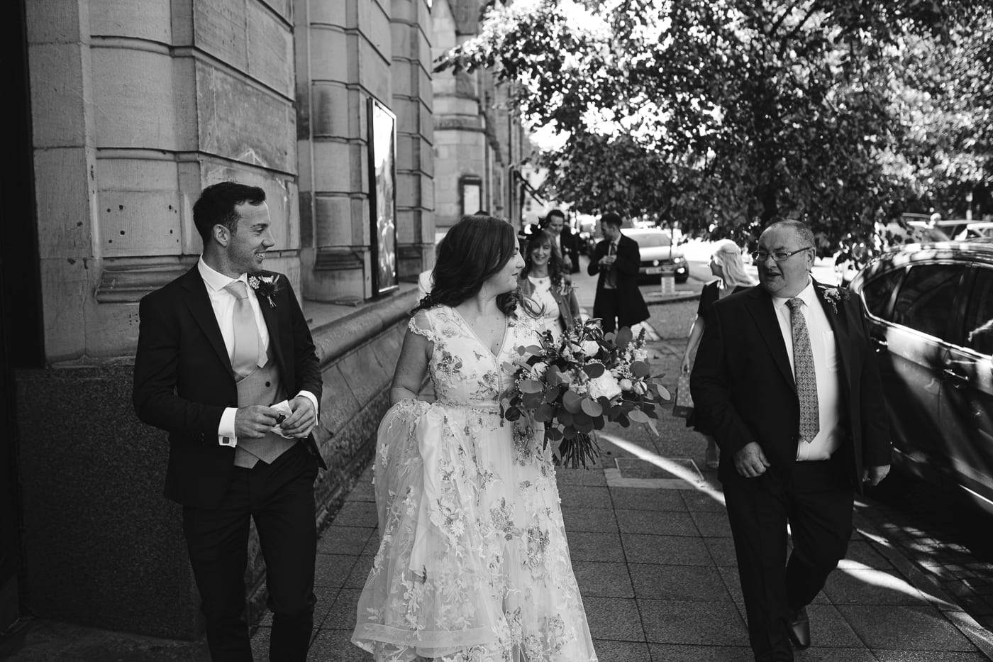 Hexham House Wedding - Black and white photo of bride and groom walking down the street.