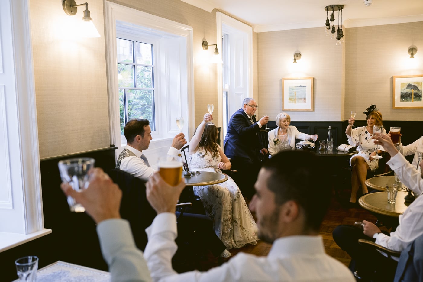 A group of people toasting at Hexham House.