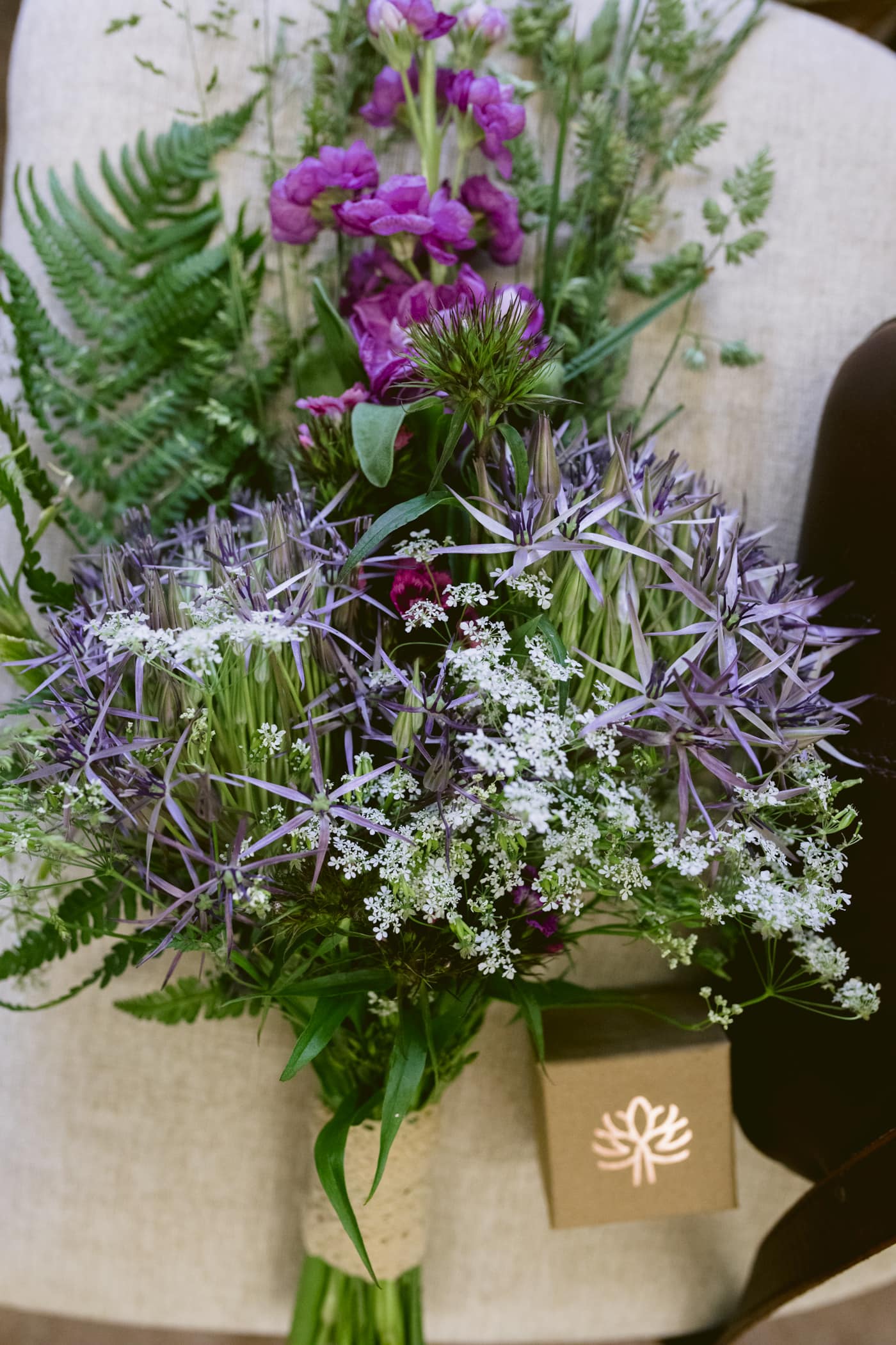 A Lake District Civil Partnership ceremony featuring a stunning bouquet of purple and green flowers adorning a chair.
