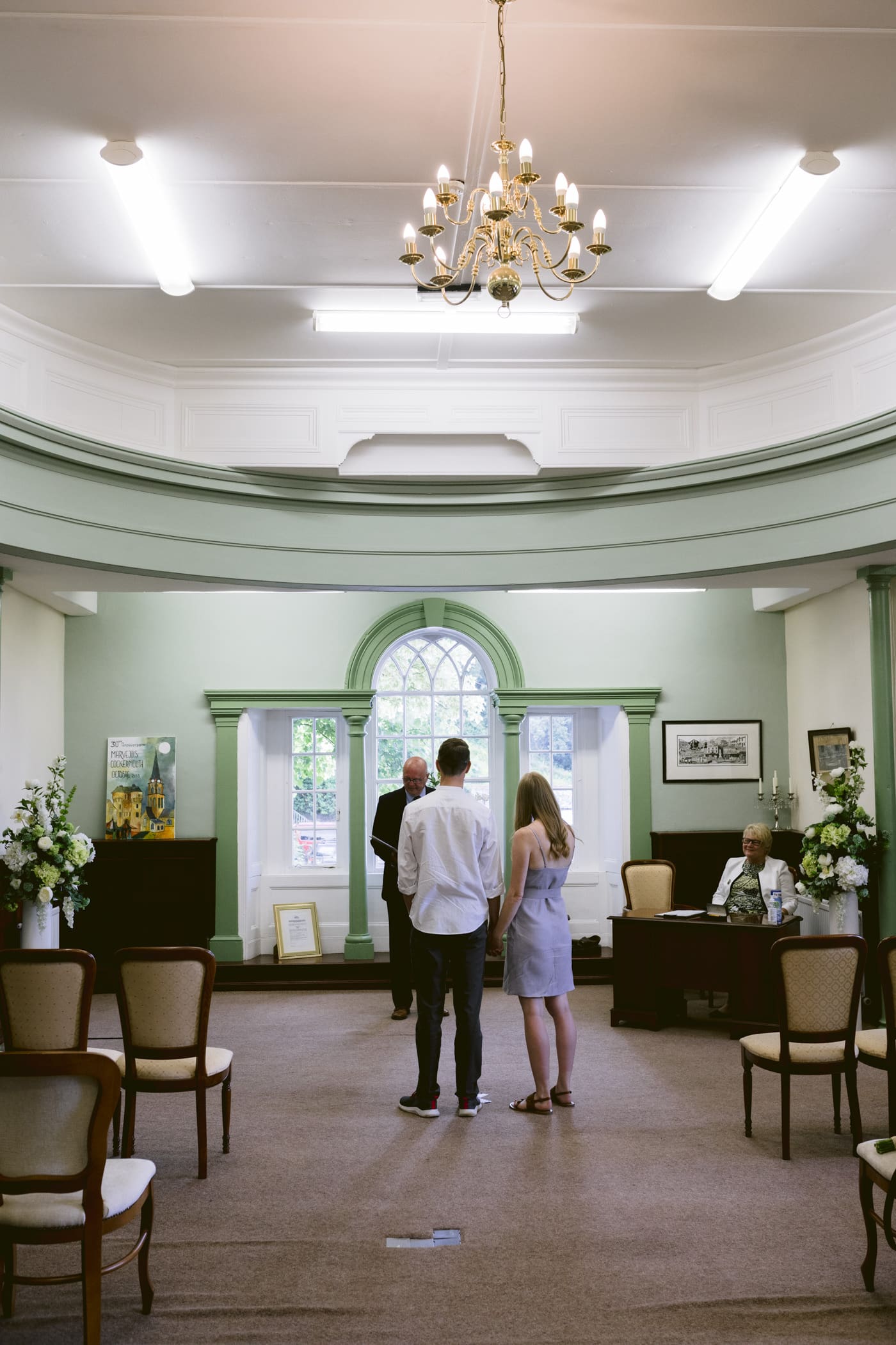 Two people standing in the middle of a Lake District room during their Civil Partnership.