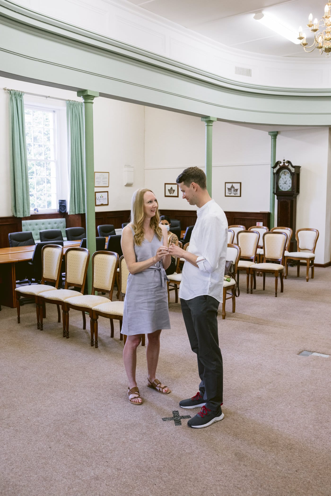 A man and a woman standing in a room, celebrating their Civil Partnership in the Lake District.