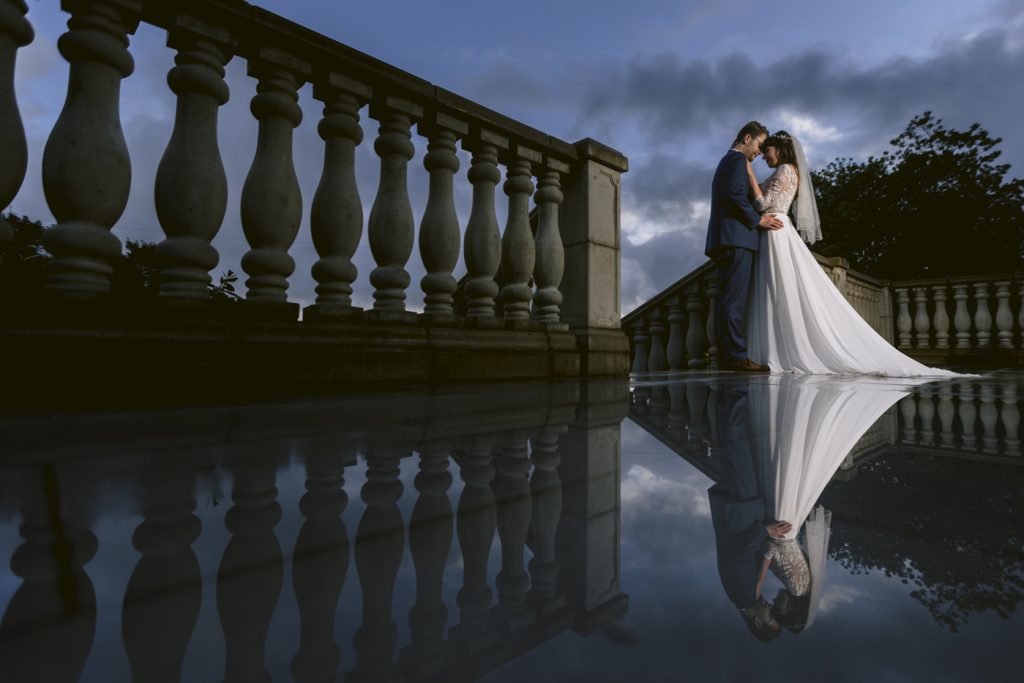 Bride and Groom Wedding Photograph at Cartmel Old Grammar House wedding portrait with real puddle reflection