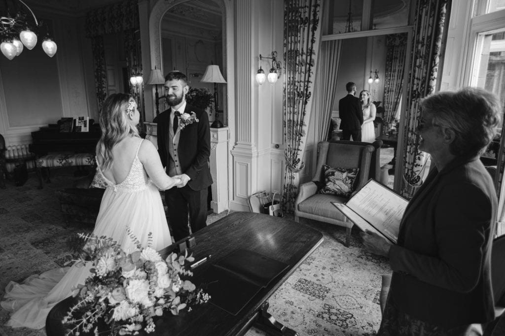 Just Us Wedding: A bride and groom standing in front of a mirror at Merewood Hotel.