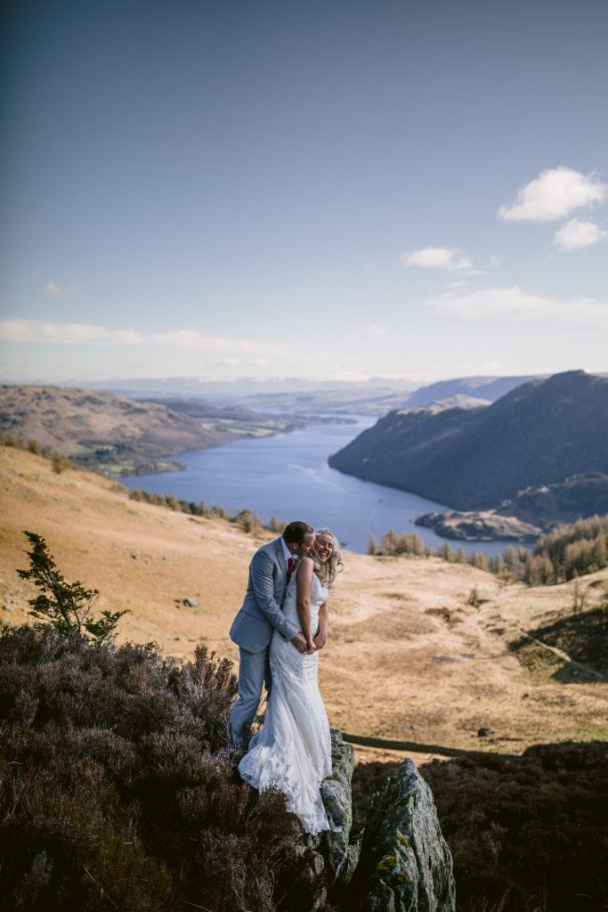 bride and groom on a lake district fell overlooking ullswater