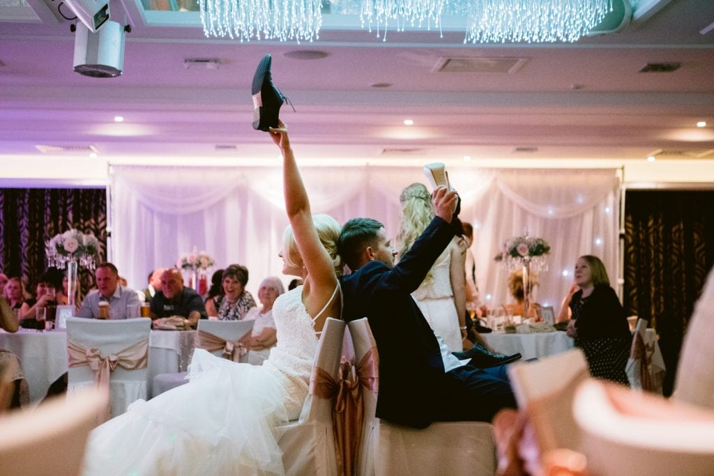 Bride & Groom playing The Shoe Game at a wedding
