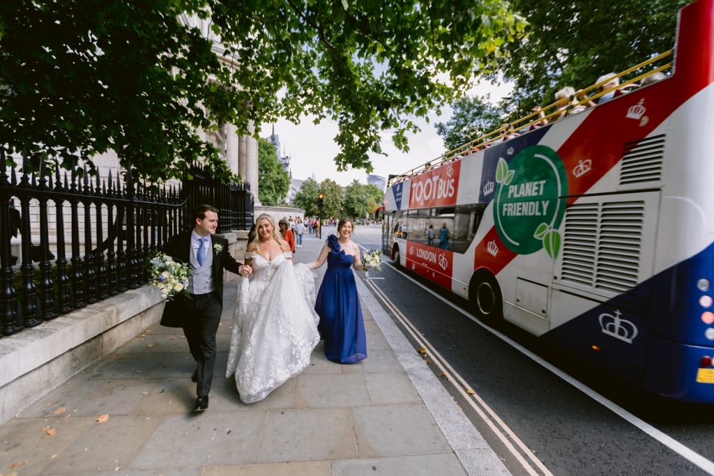 A bride and groom walk past St Paul's Cathedral in London on their wedding day.
