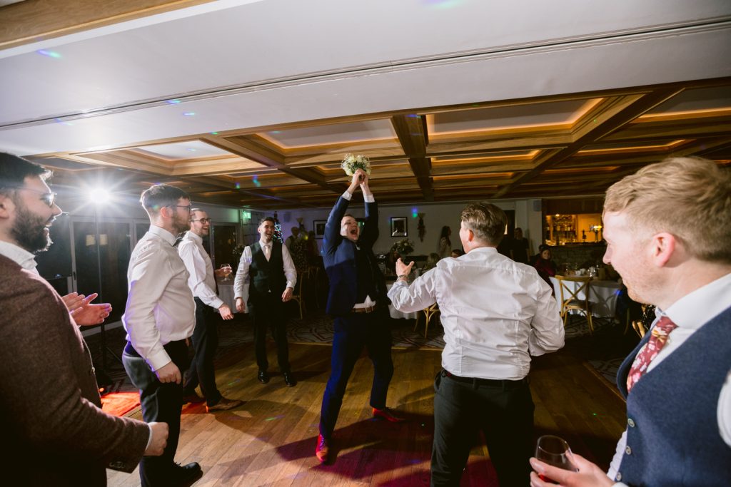 A group of people dancing at a [Winter Wedding] reception