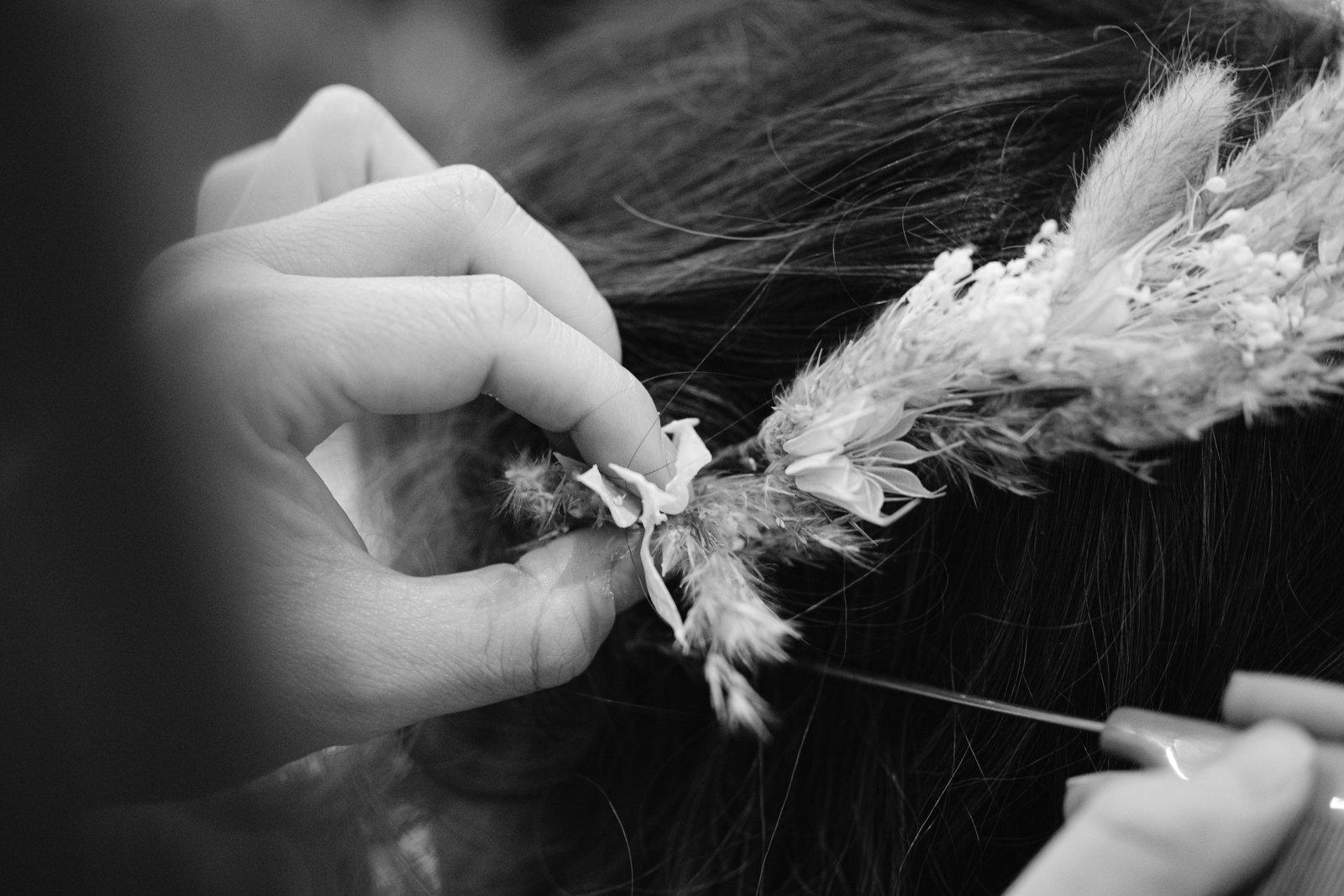 A woman is getting her hair done at Gretna Hall Wedding by a hairdresser.