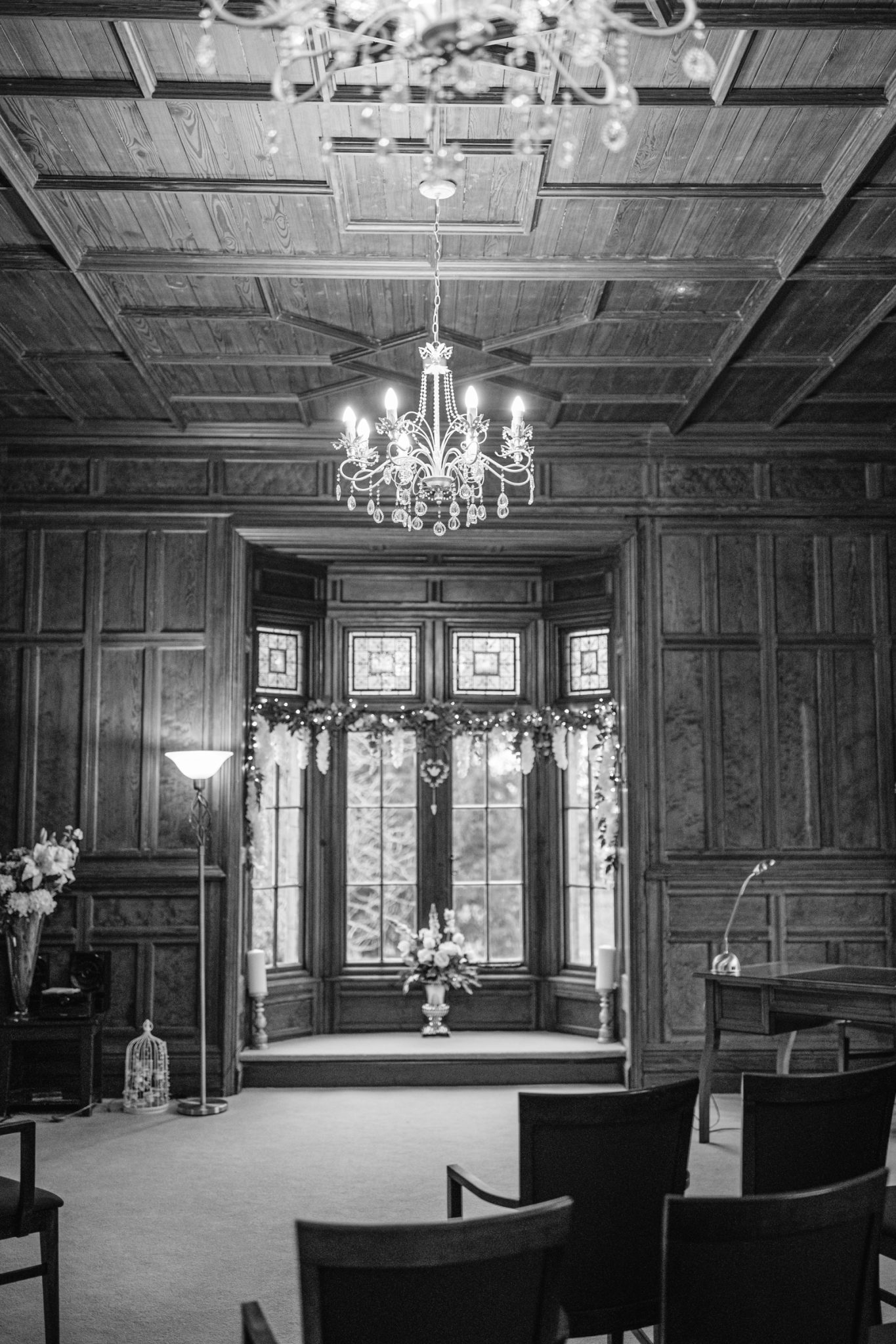 A black and white photo of a Winter wedding ceremony at Lady Gillford's house.