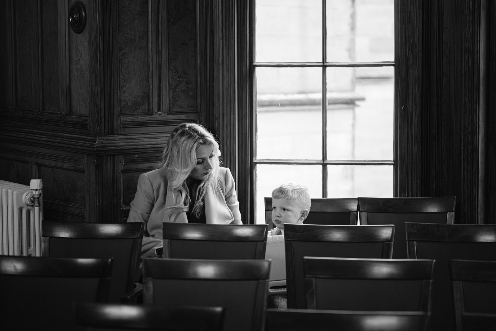 An auto draft black and white photo capturing a woman in an empty room.