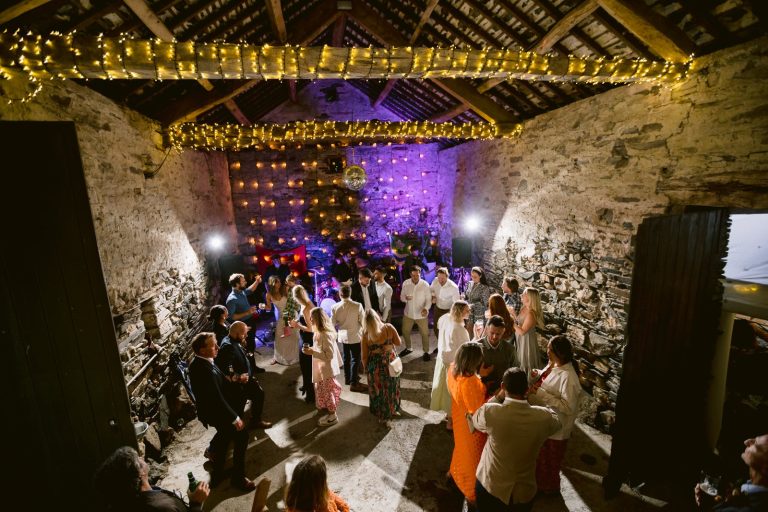 A group of people dancing at Yew Tree Farm during a Summer Wedding.