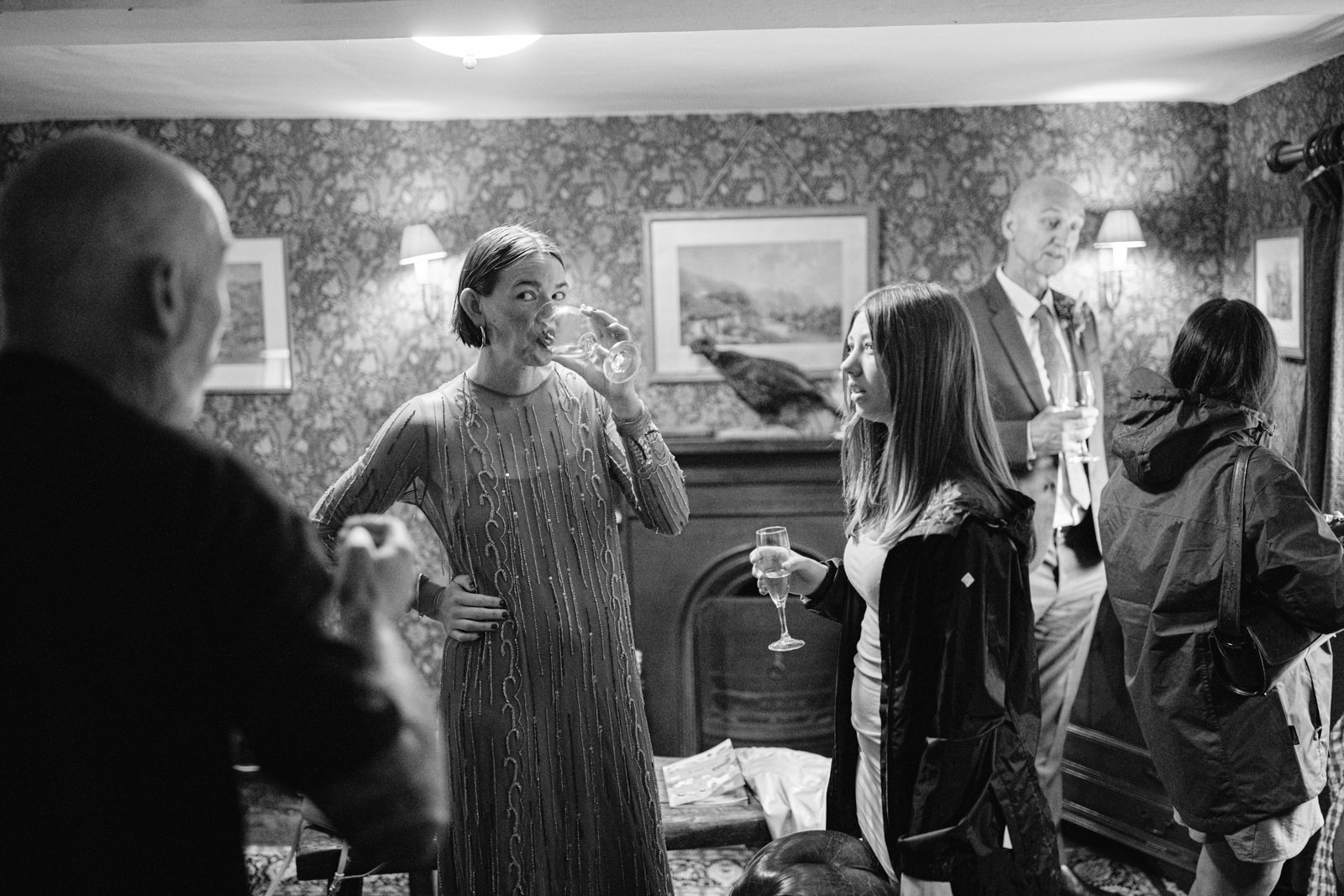 A black and white photo of a group of people at a summer wedding.