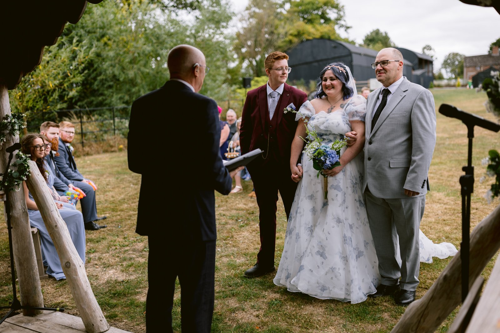 A bride and groom outside at a rustic farm wedding, celebrating their love in an LGBT+ friendly wedding near Shrewsbury.
